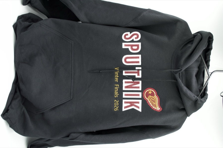 SPUTNIK Winter Finals 2026 black hoodie with embroidered lettering and winged-wheel patch, front view
