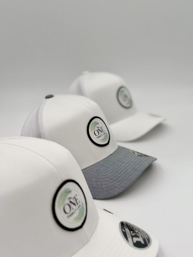 The One Family LLC white and heather grey caps with circular embroidered patches