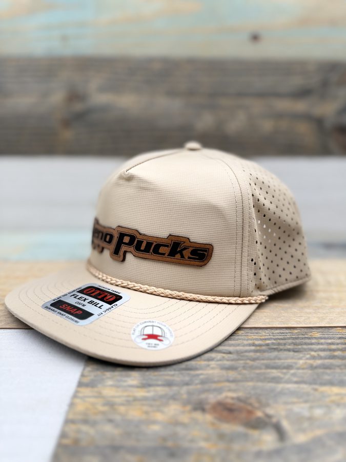 Xeno Pucks tan perforated performance cap with a rope accent and engraved leather patch